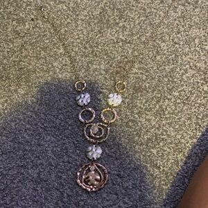 A Shein necklace that has silver tan sparkles I think real diamonds on